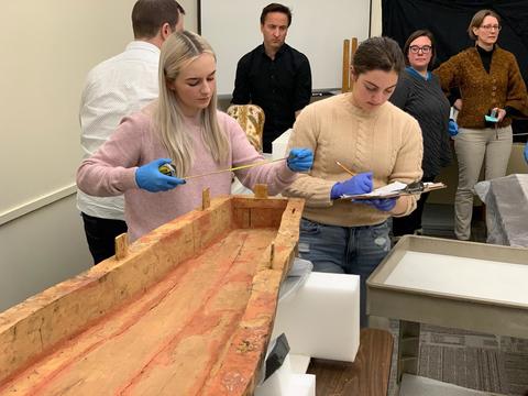 jessica Gebhard and Madeline Liberman measure coffins